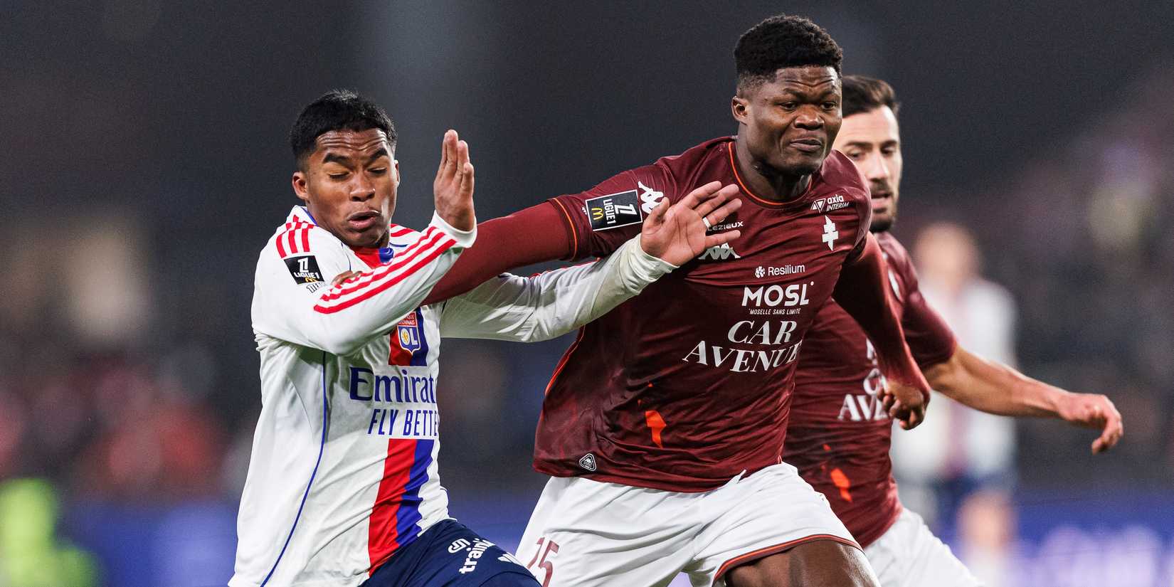 Endrick de Sousa of Lyon (L) is challenged by Terry Yegbe of FC Metz