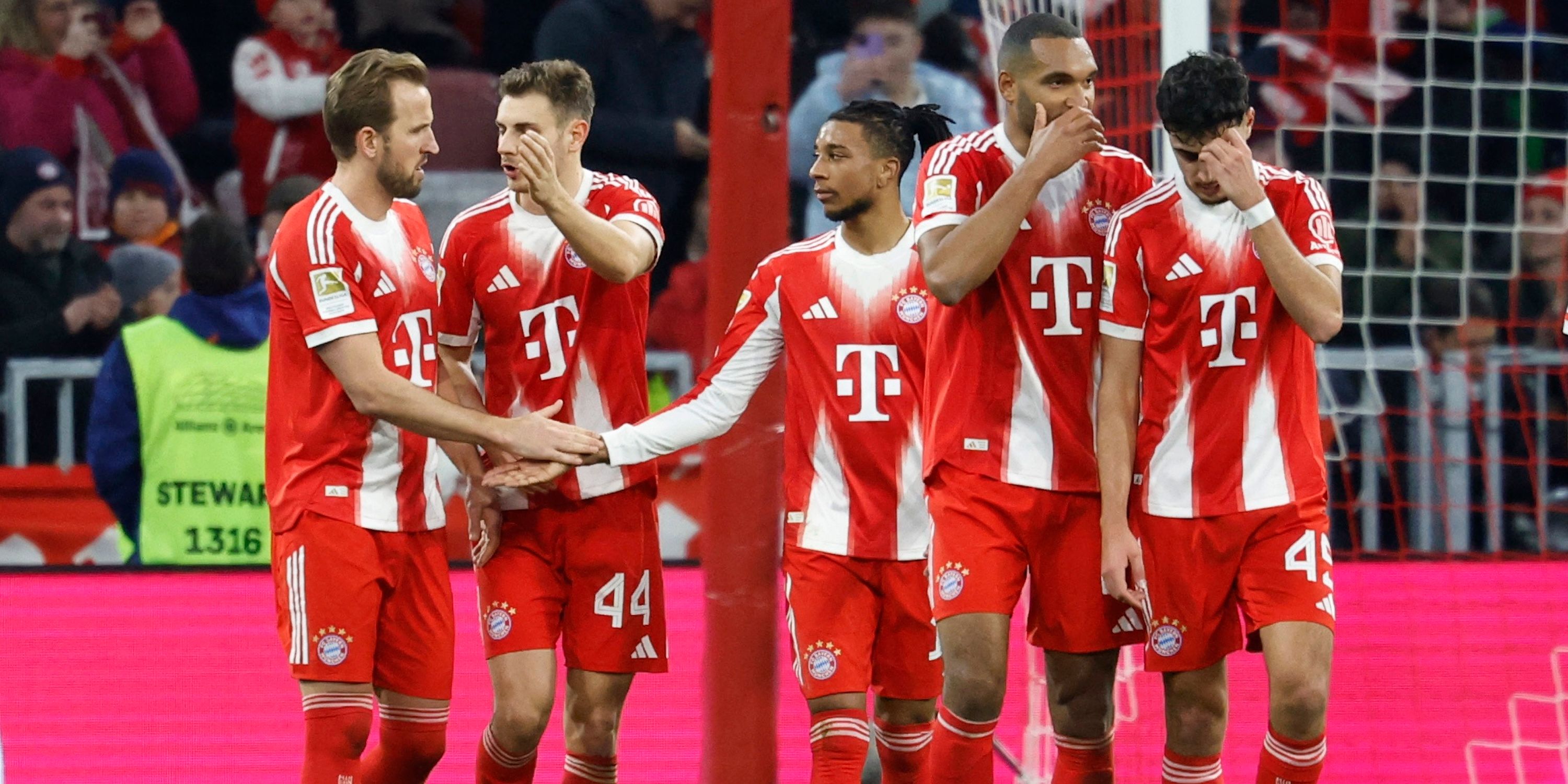 Bayern Munich's Harry Kane celebrates scoring their second goal with Michael Olise