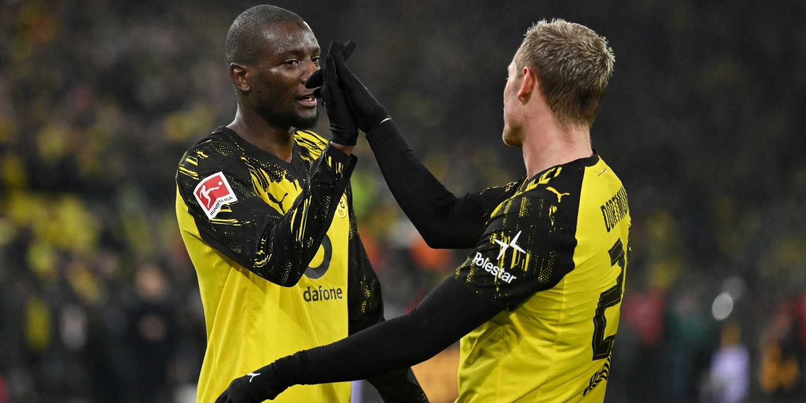 Borussia Dortmund's Serhou Guirassy celebrates scoring their third goal with Julian Ryerson