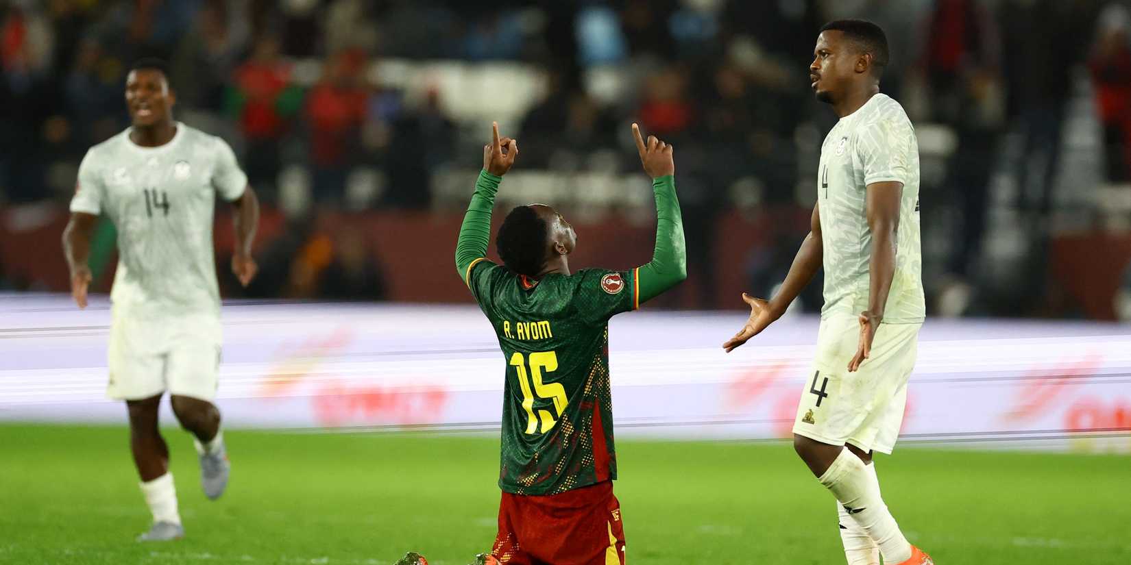 Cameroon's Arthur Avom celebrates after the match as South Africa's Teboho Mokoena looks dejected
