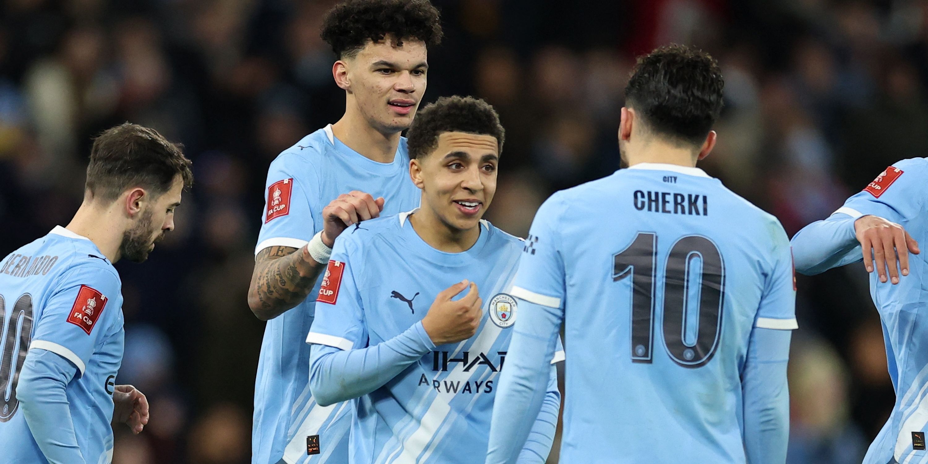 Manchester City's Nico O'Reilly celebrates scoring their eighth goal with Rico Lewis and Rayan Cherki