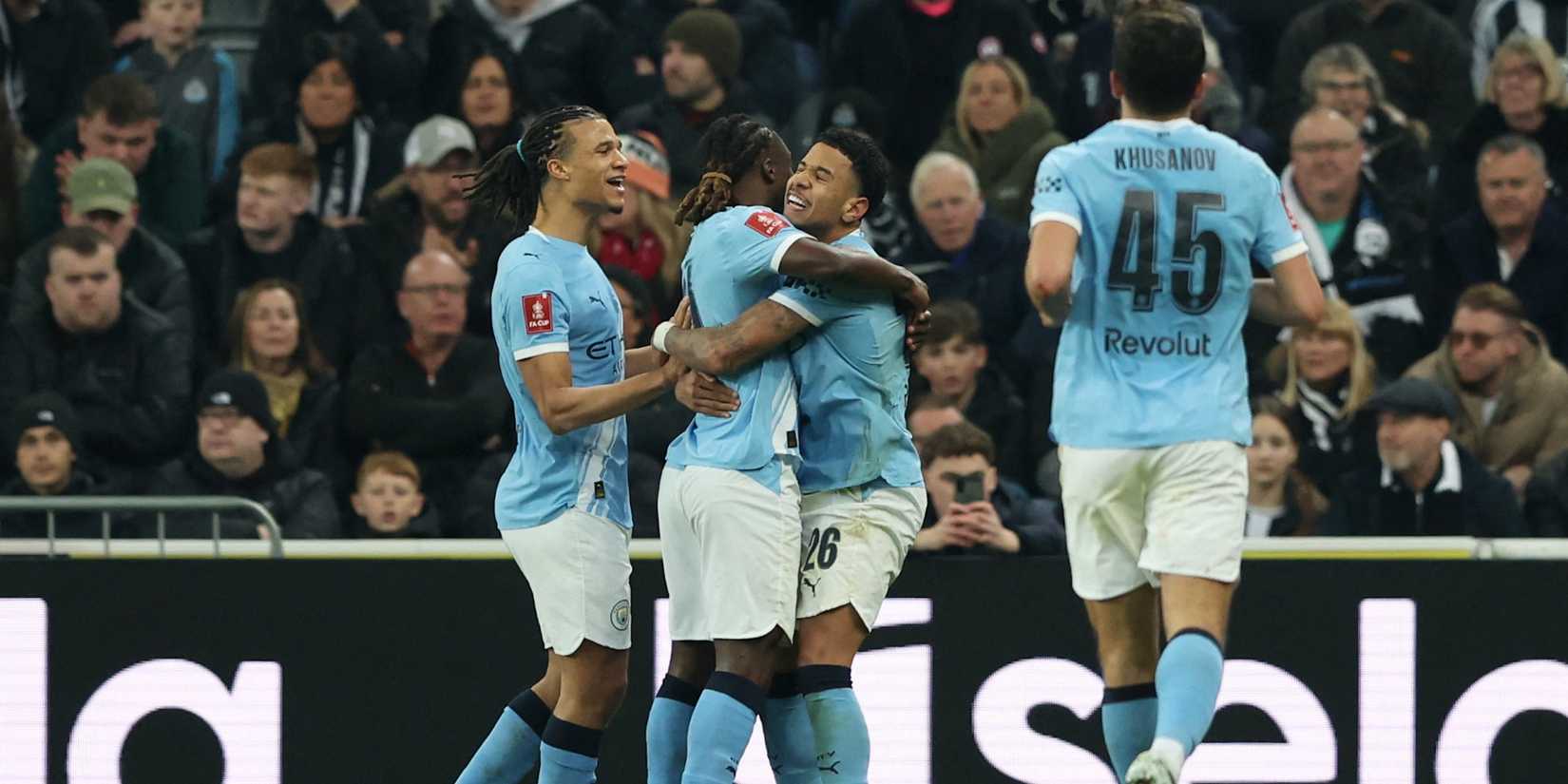 Manchester City's Savinho celebrates scoring his first goal with Manchester City's Jeremy Doku and Manchester City's Nathan Ake. 
