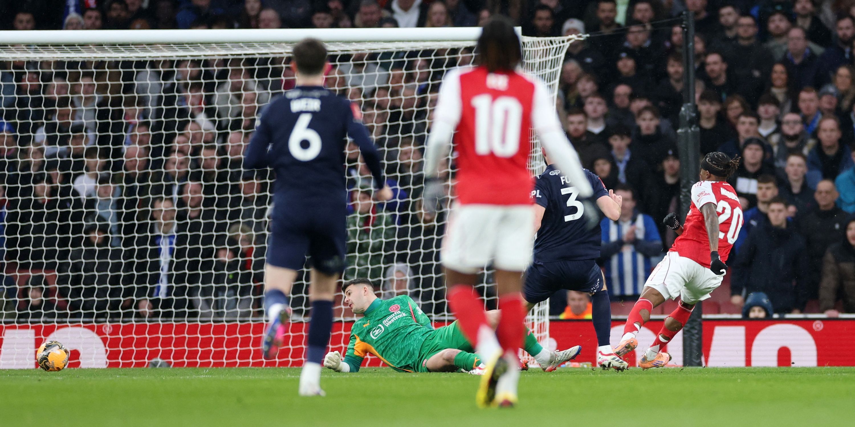  Arsenal's Noni Madueke scores their first goal past Wigan Athletic's Sam Tickle