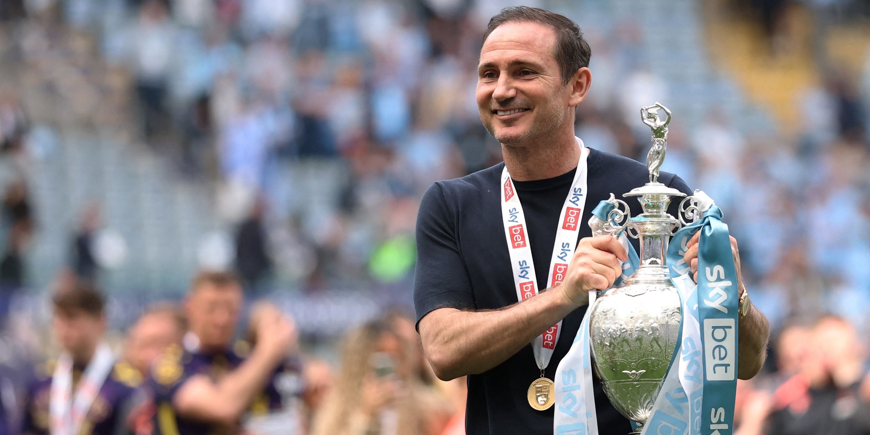 Coventry City manager, Frank Lampard, celebrates the trophy after winning the Championship