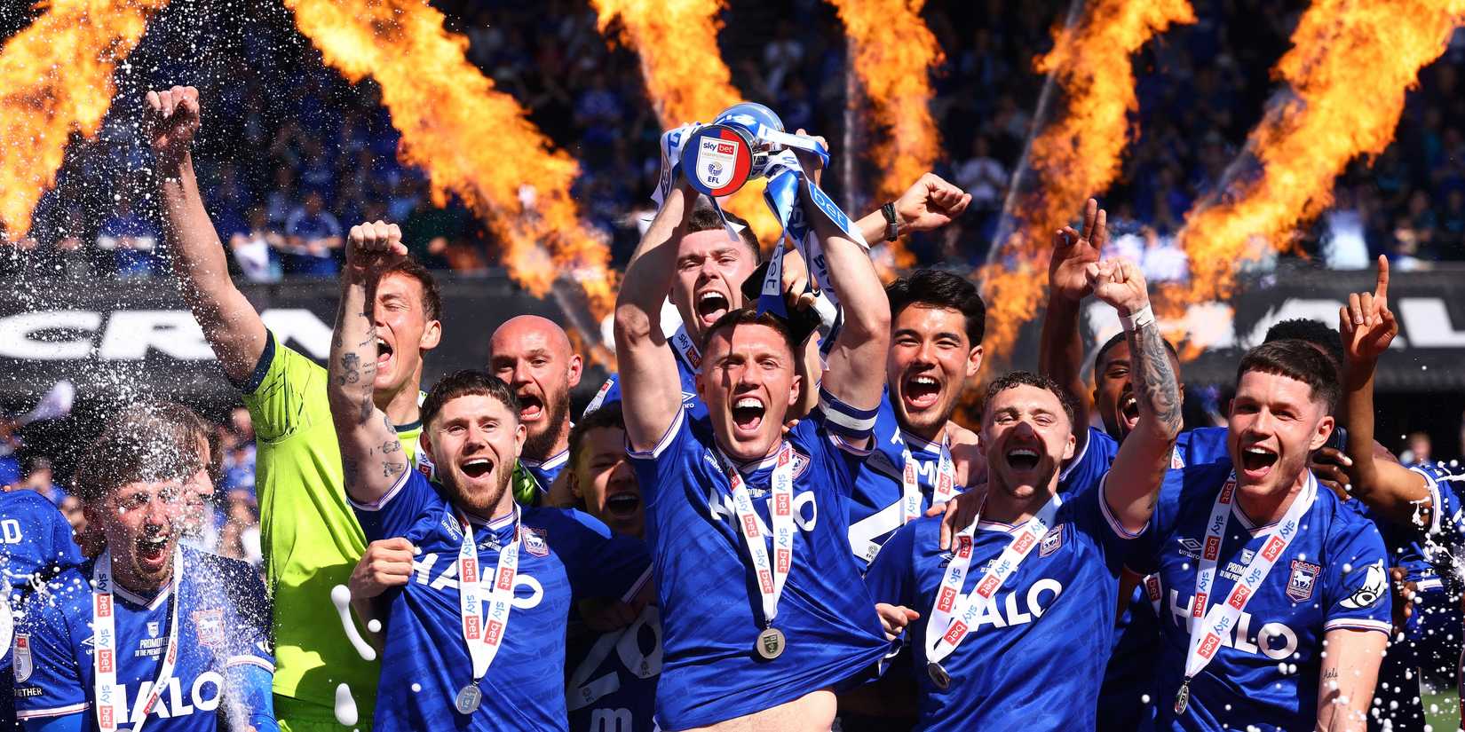 Ipswich Town players celebrate with a trophy after winning promotion to the Premier League 