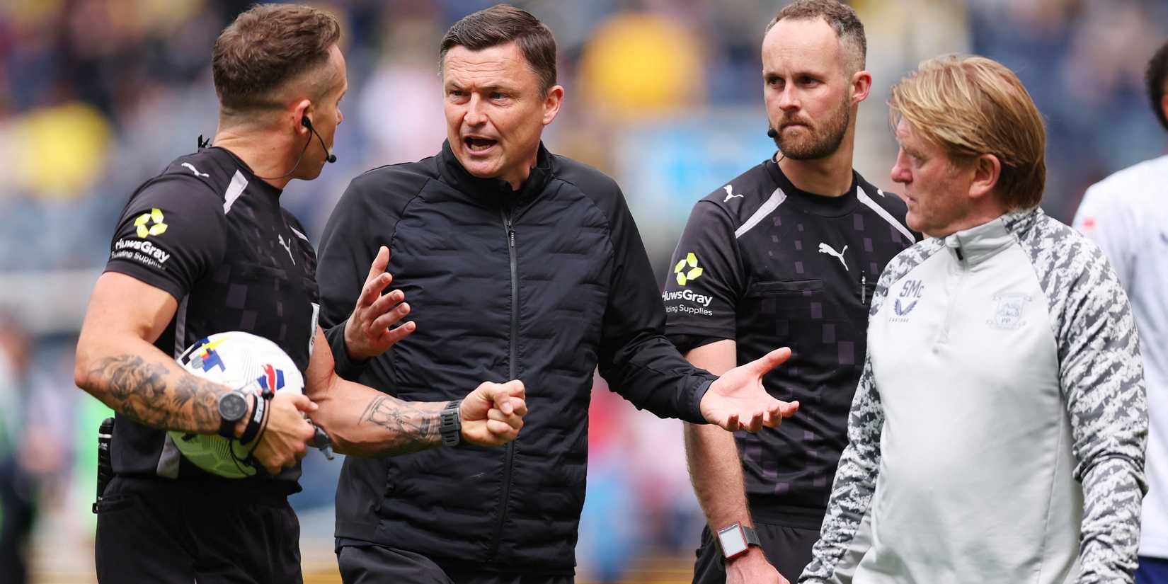  Referee Stephen Martin speaks with Preston North End manager Paul Heckingbottom and assistant manager Stuart McCall