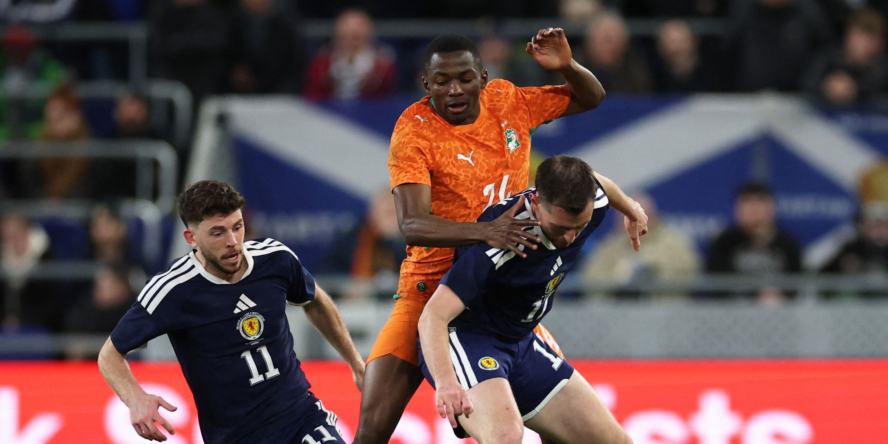 Ivory Coast's Bazoumana Toure in action with Scotland's Ryan Christie and Dominic Hyam