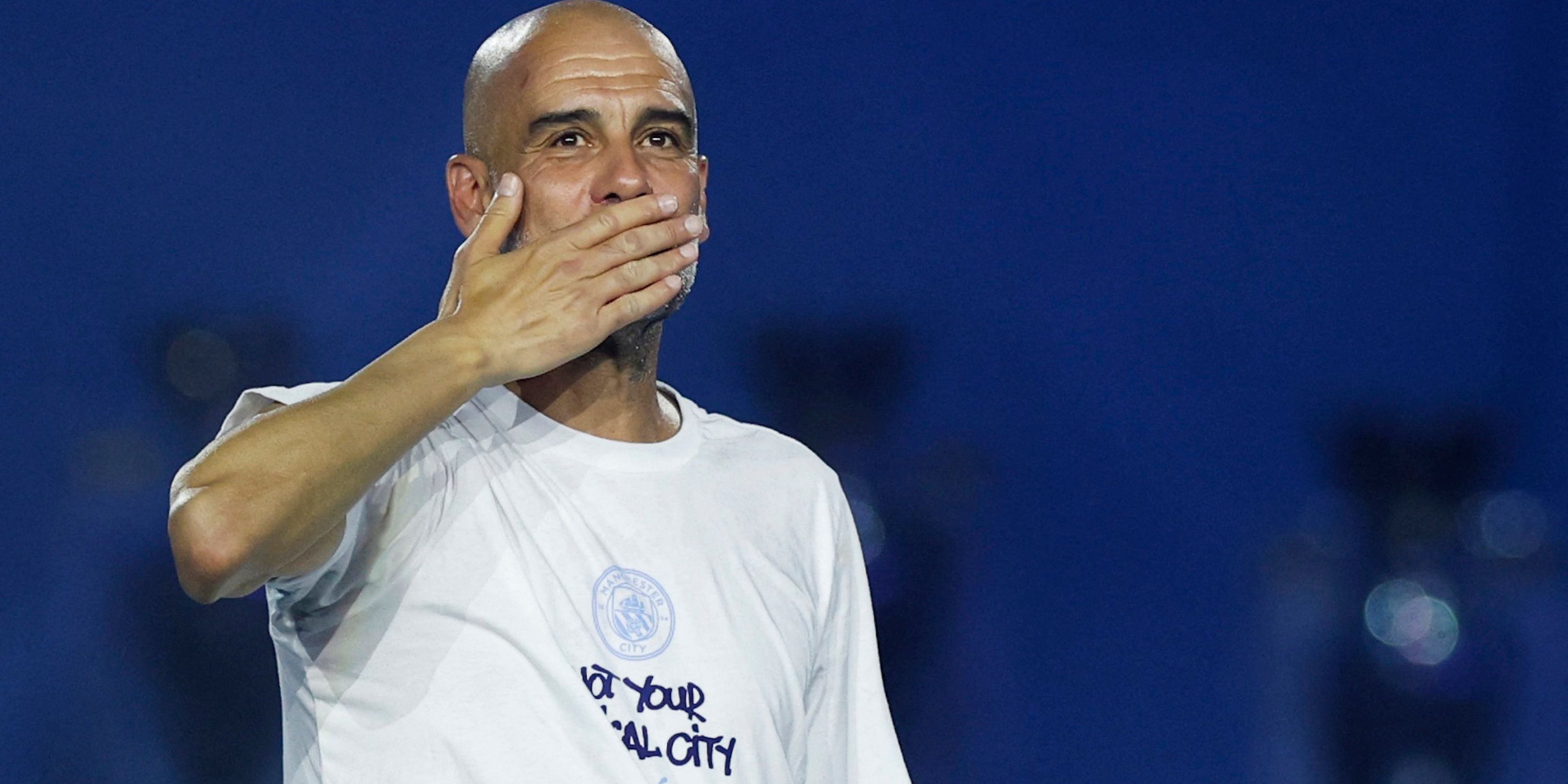 Manchester City manager Pep Guardiola celebrates after the victory parade