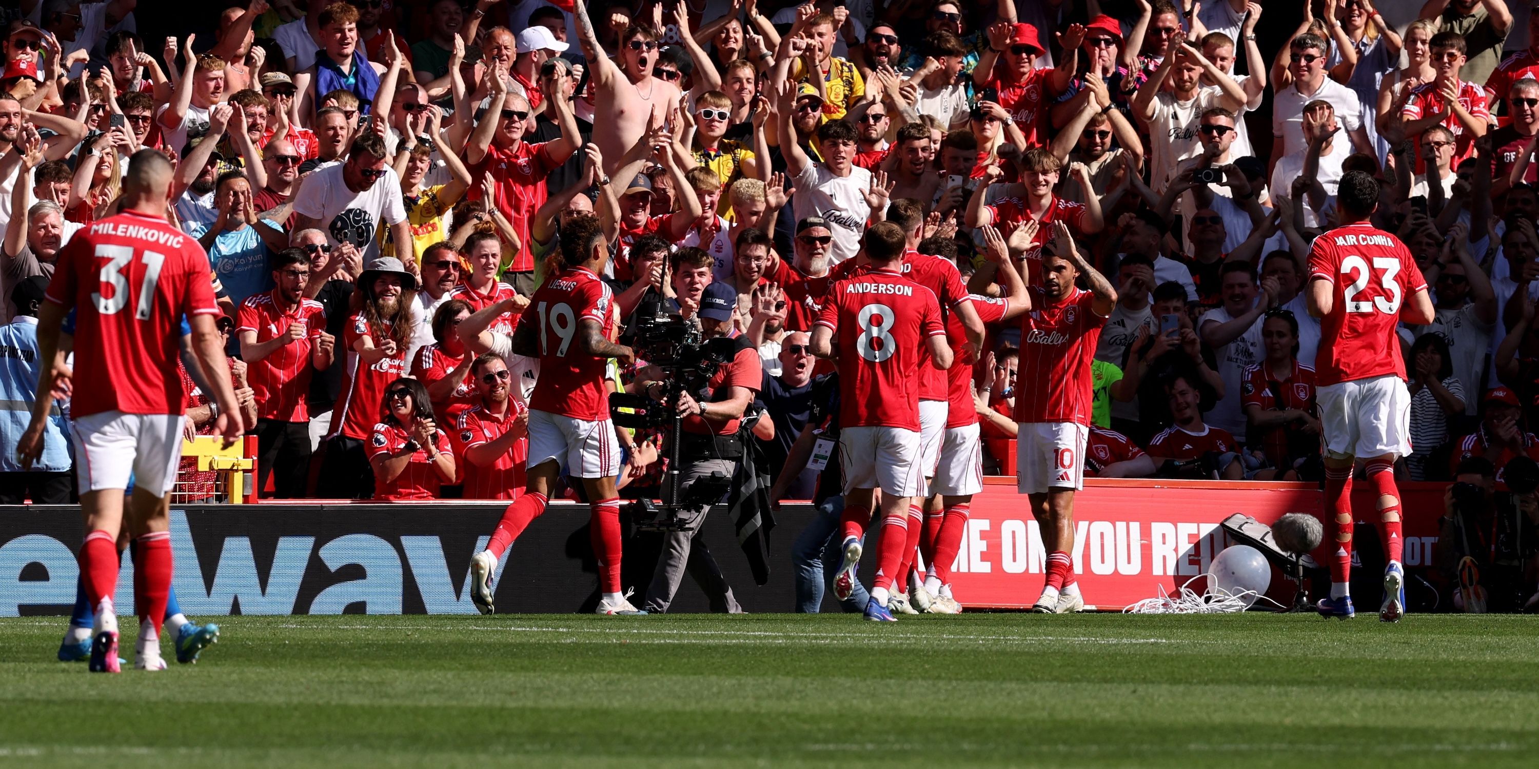 Nottingham Forest's Morgan Gibbs-White celebrates scoring their first goal with teammates in front of their fans