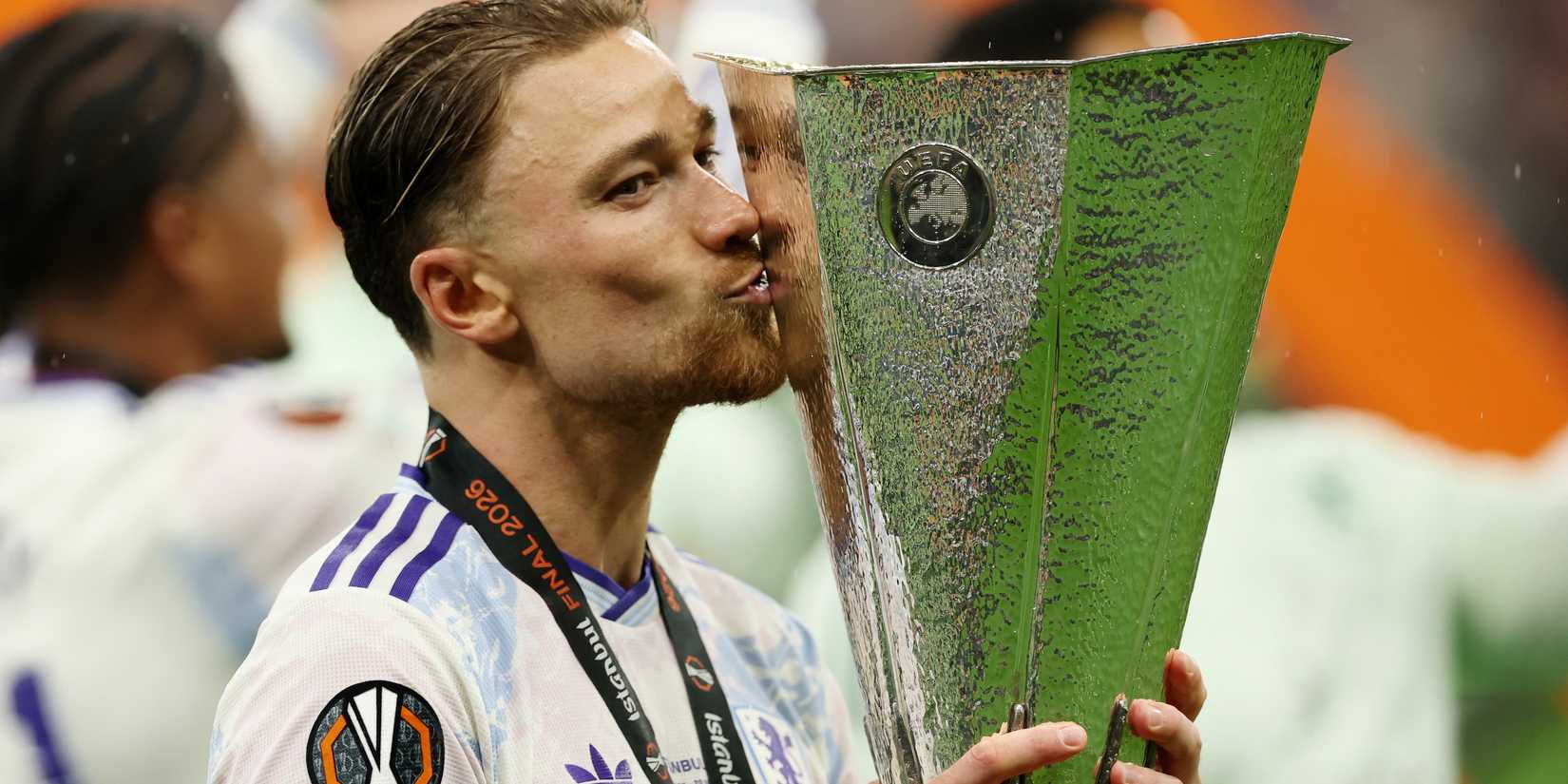 Aston Villa's Matty Cash kisses the trophy as he celebrates after winning the UEFA Europa League