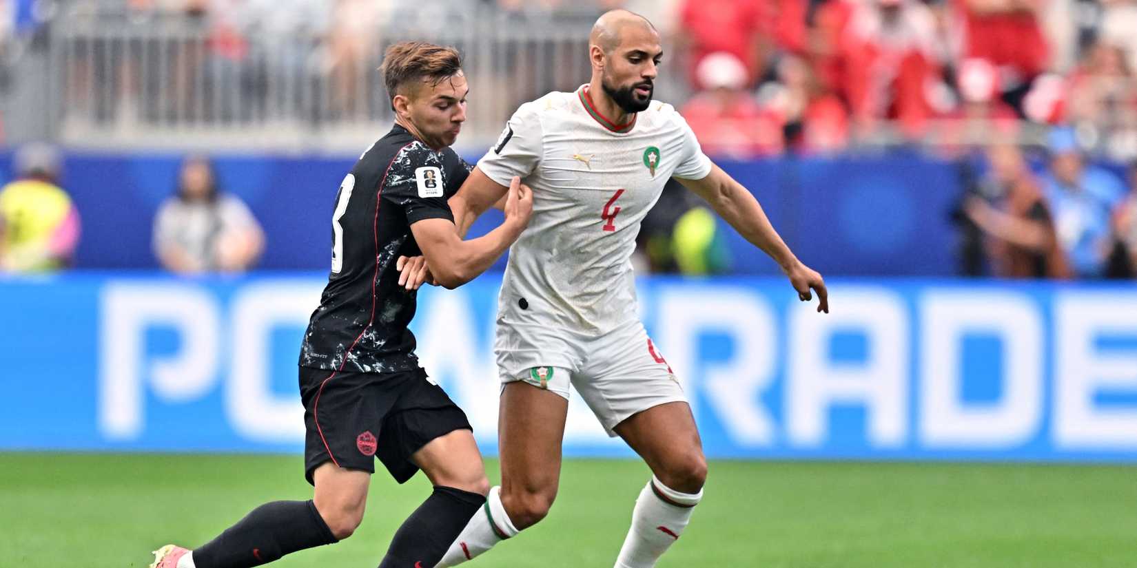 Morocco's Sofyan Amrabat in action with Canada's Niko Sigur