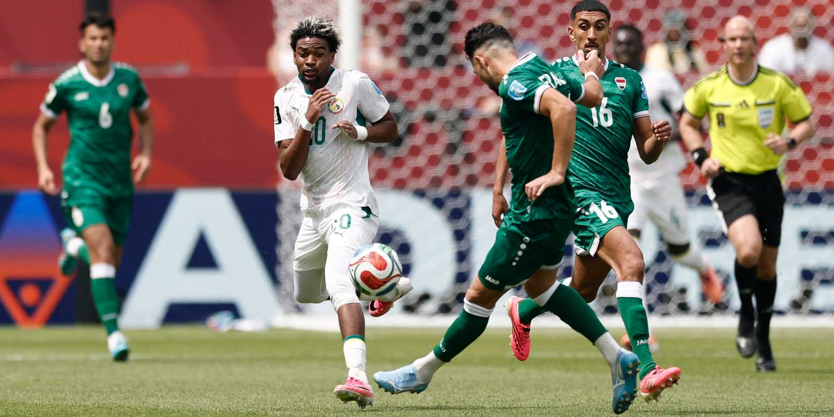 Senegal's Ibrahim Mbaye in action with Iraq's Frans Putros
