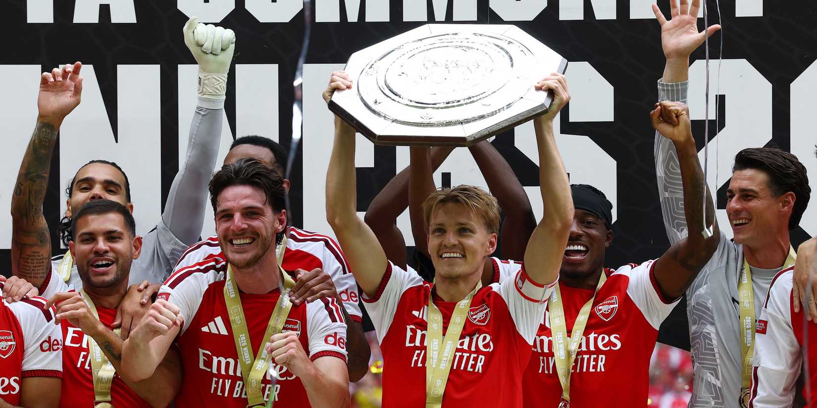 Arsenal's Martin Odegaard lifts the trophy as he celebrates with teammates after winning the FA Community Shield