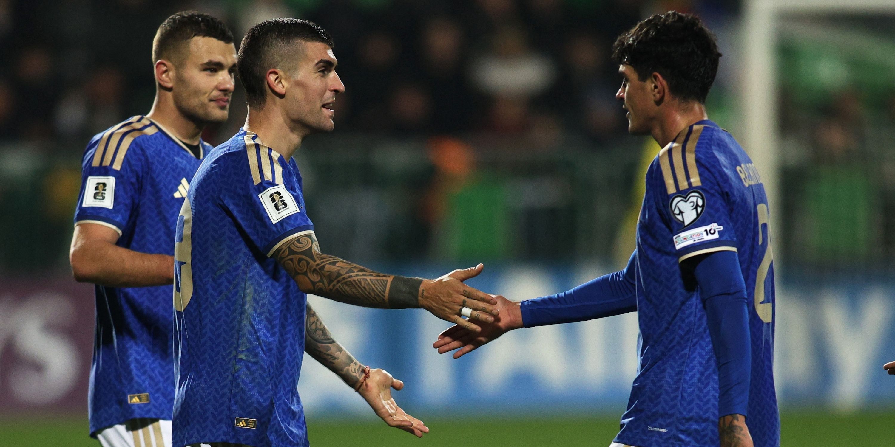 Italy's Gianluca Mancini and Raoul Bellanova celebrate after the match 