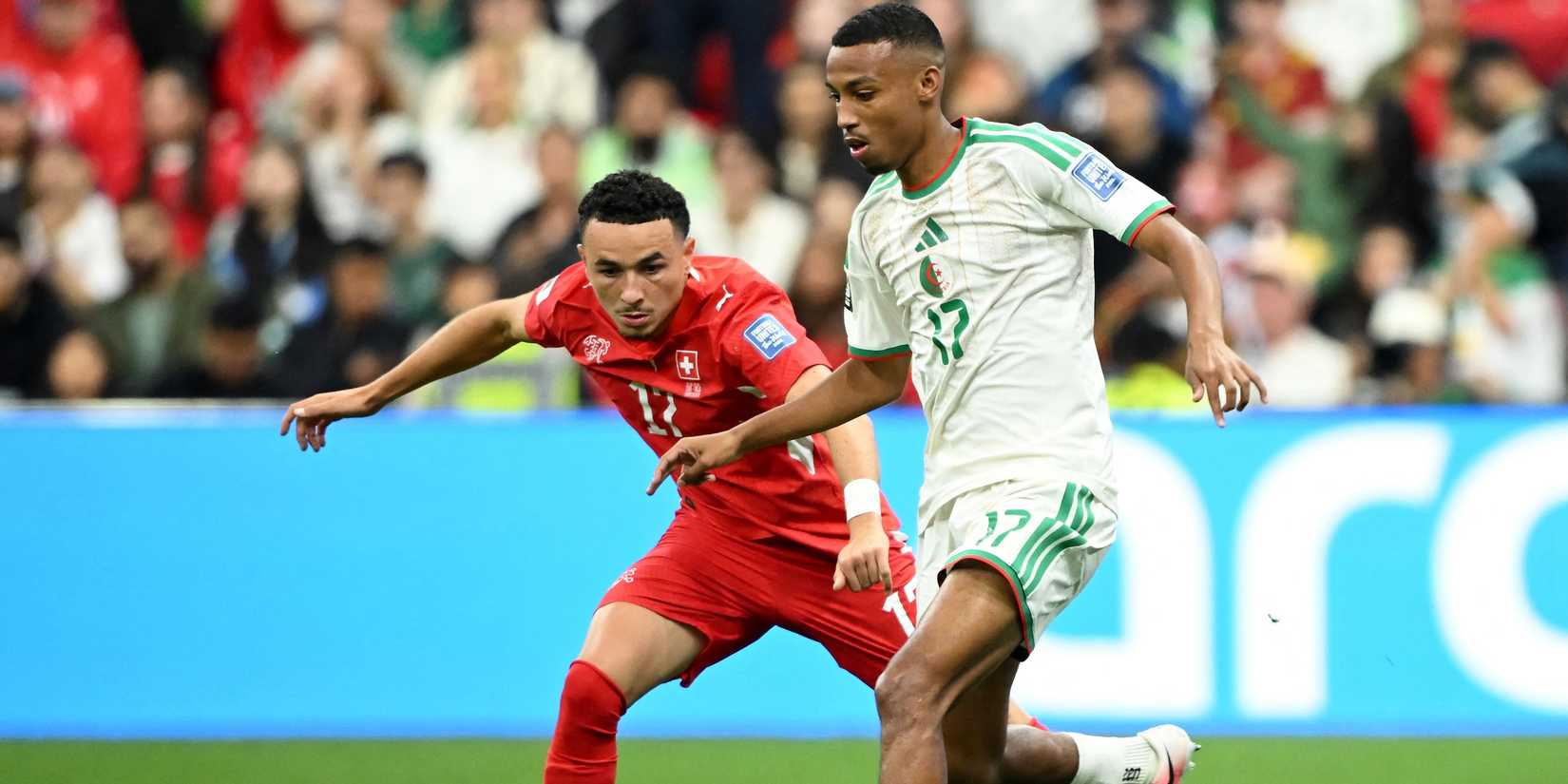 Switzerland's Ruben Vargas in action with Algeria's Rafik Belghali 