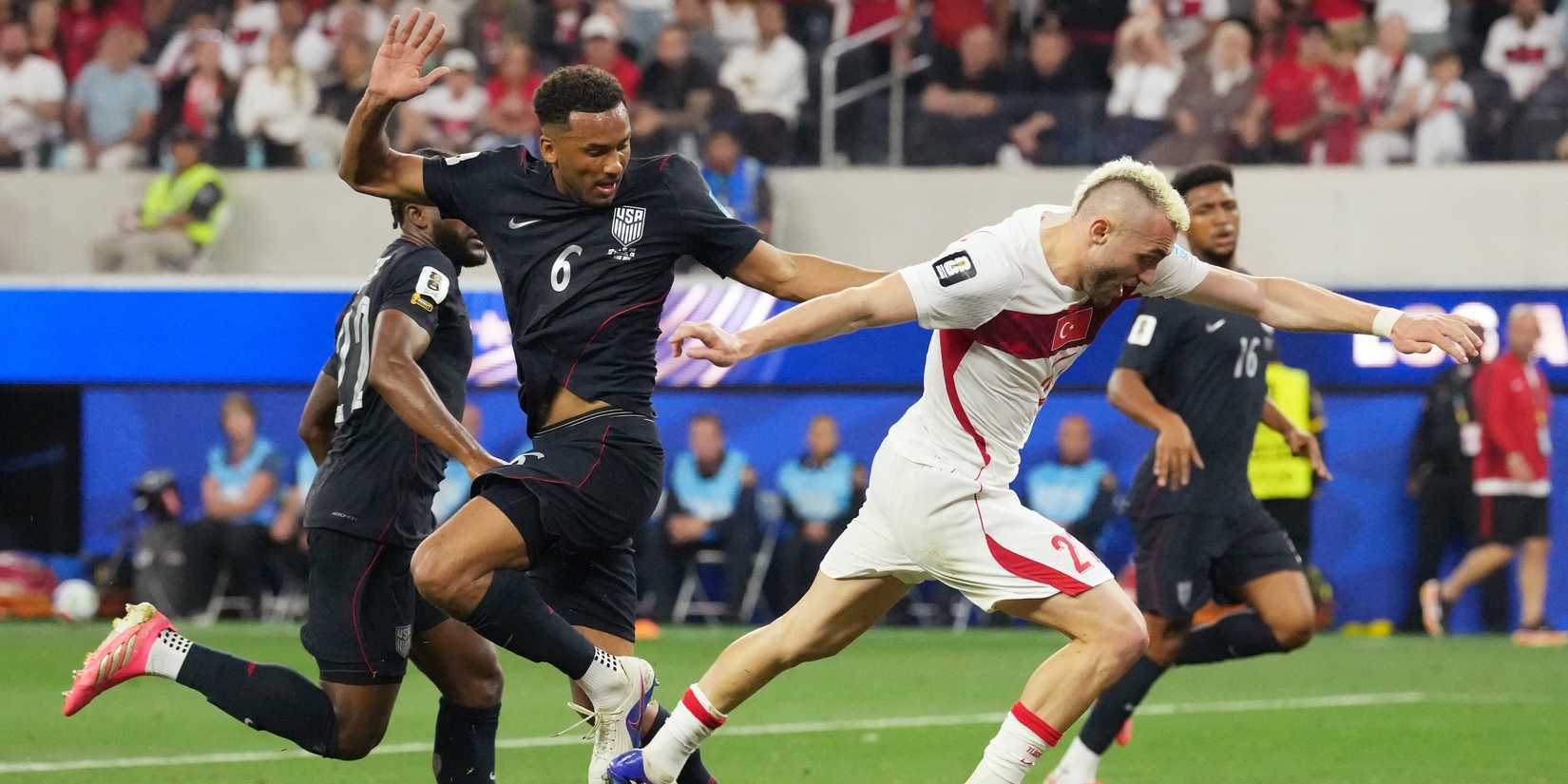 Turkey's Baris Alper Yilmaz in action with Auston Trusty of the U.S.