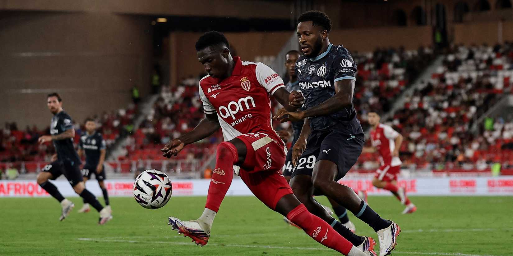 AS Monaco's Lamine Camara in action with Olympique de Marseille's Faris Moumbagna