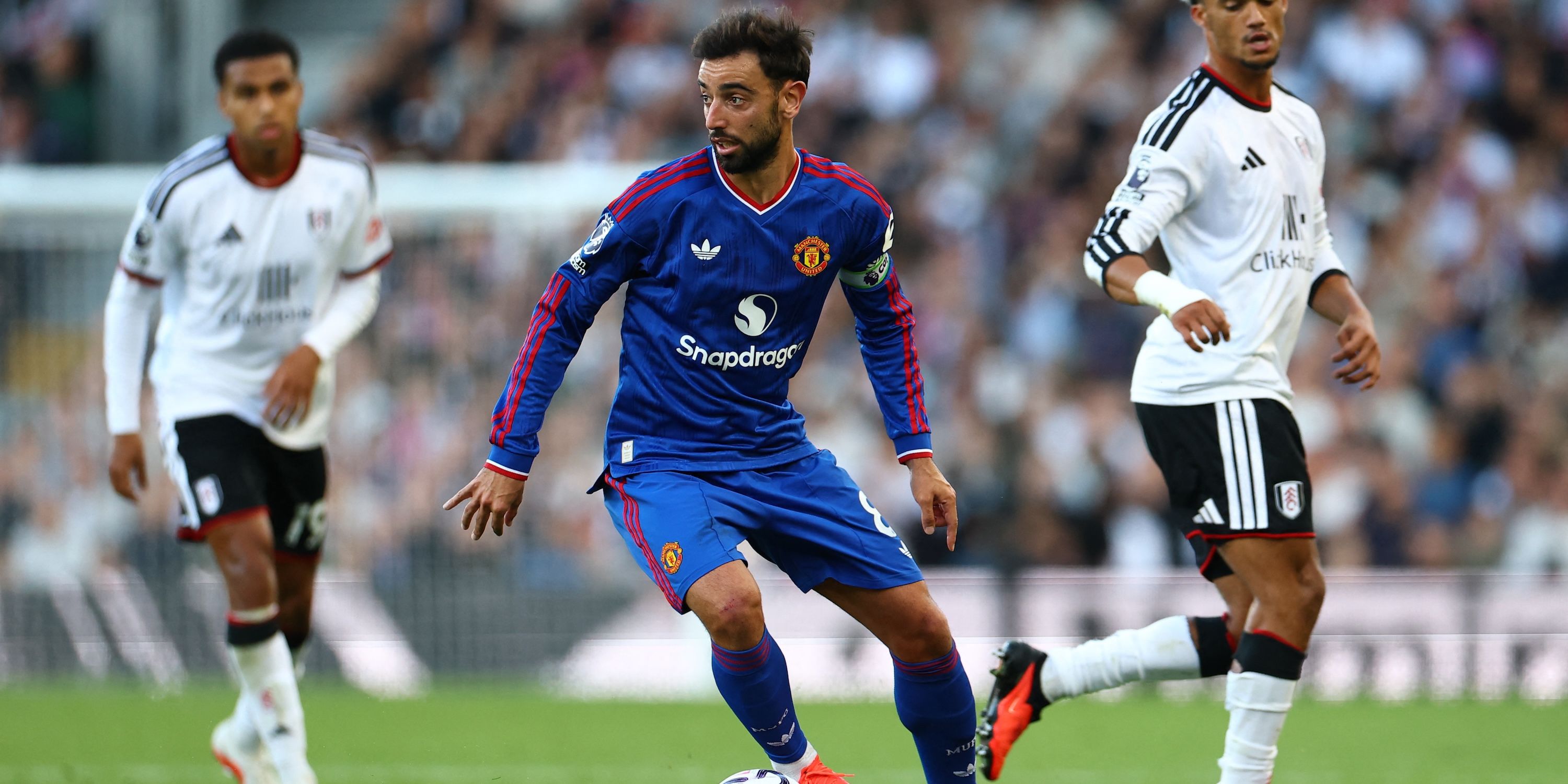 Manchester United's Bruno Fernandes in action with Fulham's Antonee Robinson